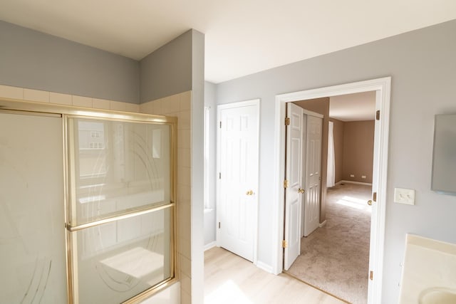 2197 Wilson Creek Cir, Aurora, IL 60503 - full bath with an enclosed shower, wood finished floors, baseboards, and vanity