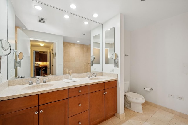 130 N Garland Ct Unit 2406, Chicago, IL 60602 - bathroom featuring recessed lighting, double vanity, toilet, and baseboards