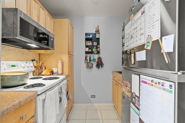 4343 N Clarendon Ave Unit 1301, Chicago, IL 60613 - kitchen featuring stainless steel appliances, light brown cabinetry, light countertops, light tile patterned floors, and baseboards