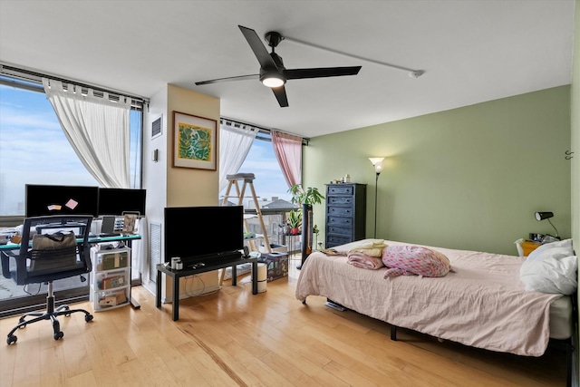 4343 N Clarendon Ave Unit 1301, Chicago, IL 60613 - bedroom with wood finished floors, a wall of windows, and ceiling fan