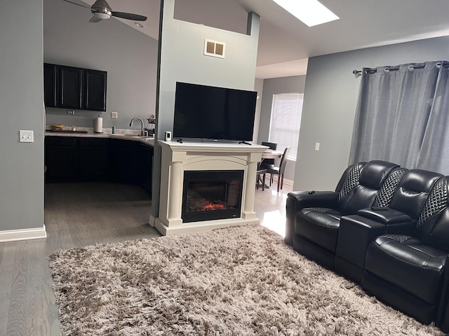 900 Windstone Ct, Lake In The Hills, IL 60156 - living area with light wood finished floors, baseboards, ceiling fan, and vaulted ceiling