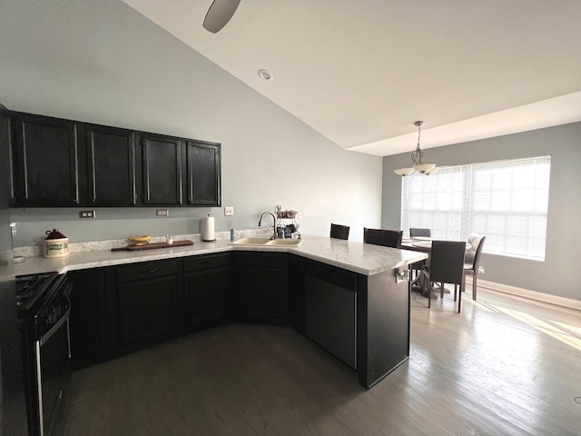 900 Windstone Ct, Lake In The Hills, IL 60156 - kitchen featuring black range with gas stovetop, dark cabinets, a sink, a peninsula, and wood finished floors