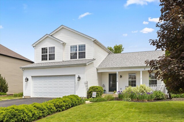 25516 W Gateway Cir, Plainfield, IL 60585 - traditional home featuring a garage, a front yard, driveway, covered porch, and roof with shingles