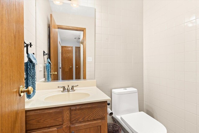 25516 W Gateway Cir, Plainfield, IL 60585 - bathroom featuring tile walls, toilet, and vanity
