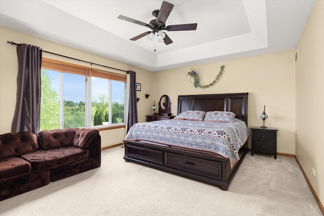 25516 W Gateway Cir, Plainfield, IL 60585 - bedroom featuring baseboards, light carpet, a raised ceiling, and a ceiling fan