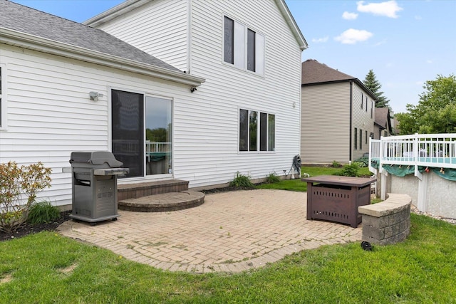 25516 W Gateway Cir, Plainfield, IL 60585 - rear view of house featuring a shingled roof, a patio, a lawn, and a wooden deck