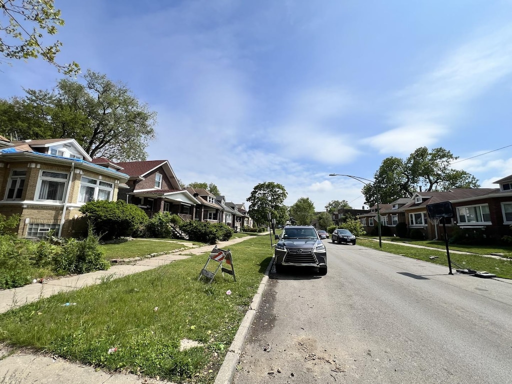 7925 S Ridgeland Ave, Chicago, IL 60617 - view of asphalt street with a residential view, street lighting, curbs, and sidewalks