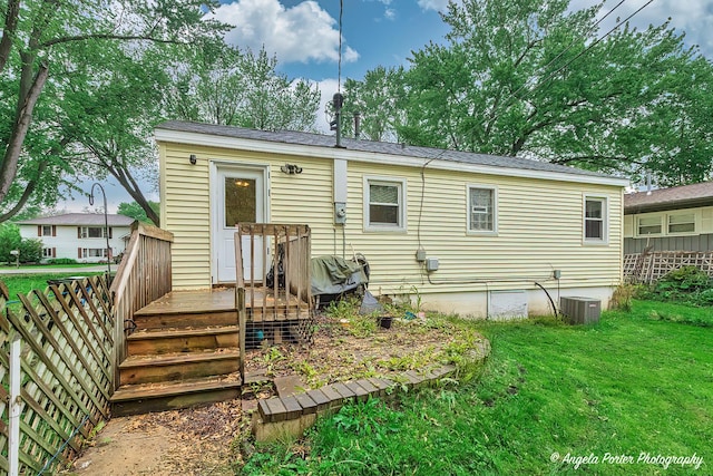 1720 Rogers Ave, Mchenry, IL 60050 - rear view of property featuring a lawn, central AC, and a wooden deck