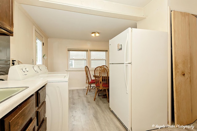 1720 Rogers Ave, Mchenry, IL 60050 - laundry area featuring light wood finished floors, washing machine and dryer, ornamental molding, and baseboards