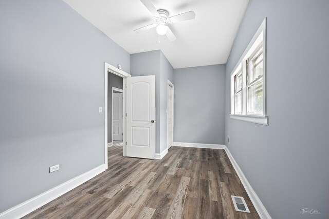 8425 S Essex Ave, Chicago, IL 60617 - unfurnished bedroom featuring wood finished floors, baseboards, and a ceiling fan