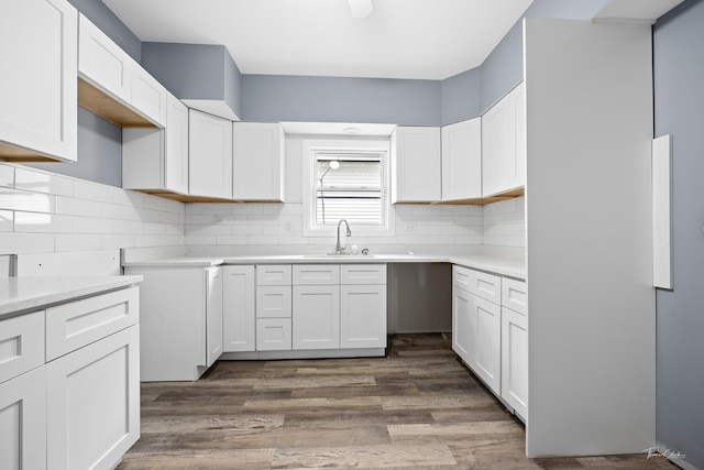 8425 S Essex Ave, Chicago, IL 60617 - kitchen featuring a sink, decorative backsplash, and white cabinetry