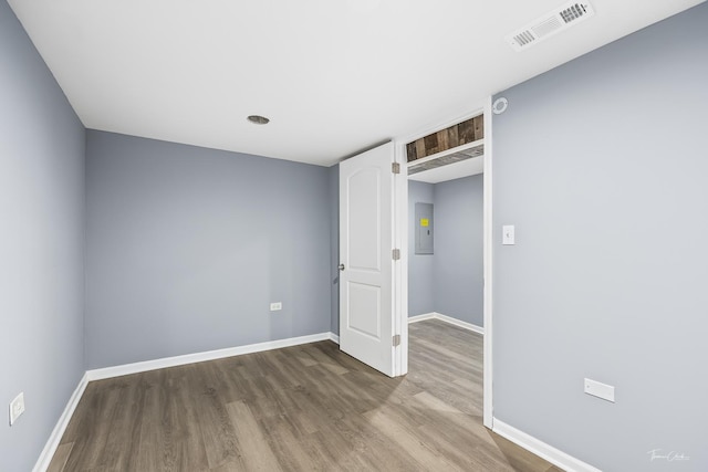 8425 S Essex Ave, Chicago, IL 60617 - spare room featuring electric panel, wood finished floors, and baseboards