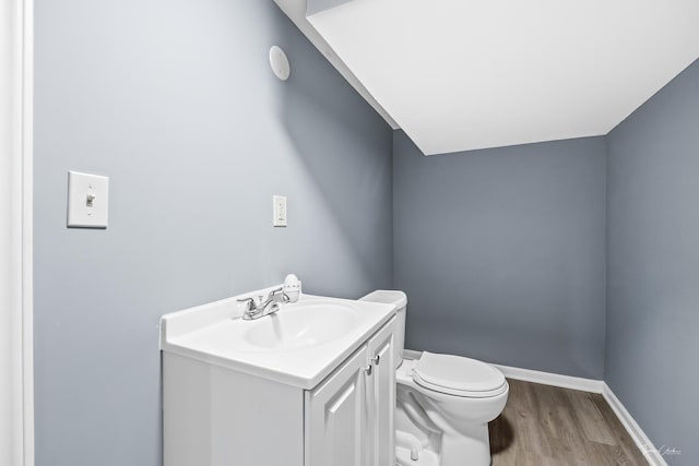 8425 S Essex Ave, Chicago, IL 60617 - half bath featuring wood finished floors, toilet, vanity, and baseboards
