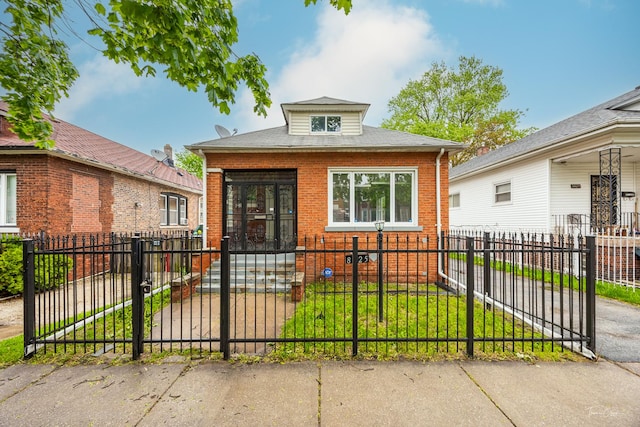 8425 S Essex Ave, Chicago, IL 60617 - bungalow-style home featuring brick siding, a fenced front yard, and a gate