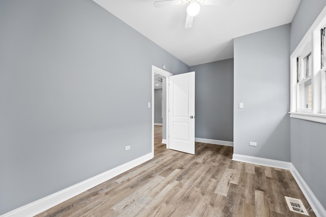 8425 S Essex Ave, Chicago, IL 60617 - unfurnished bedroom featuring wood finished floors, baseboards, and a ceiling fan