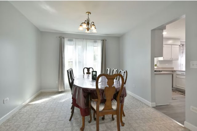 1557 Scottdale Cir, Wheaton, IL 60189 - dining area with a chandelier, light carpet, and baseboards