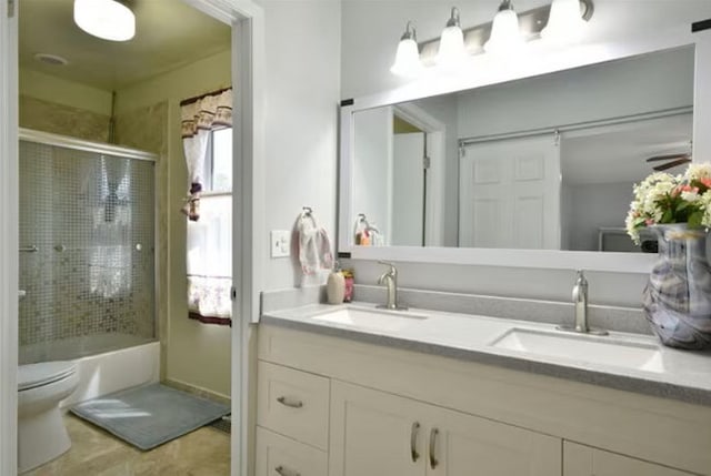 1557 Scottdale Cir, Wheaton, IL 60189 - bathroom with double vanity, toilet, and combined bath / shower with glass door