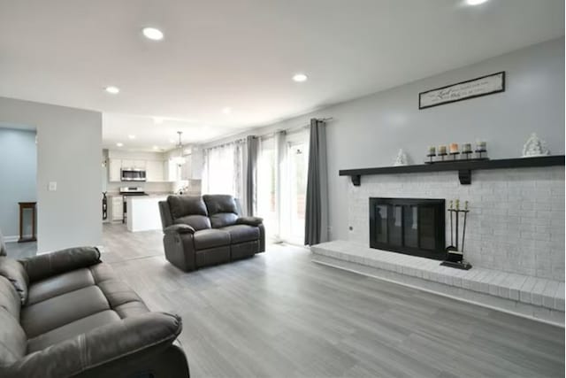 1557 Scottdale Cir, Wheaton, IL 60189 - living area with recessed lighting, a brick fireplace, and light wood-style flooring