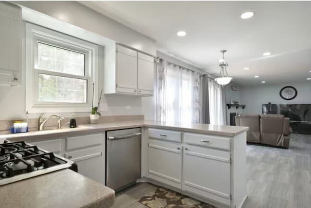 1557 Scottdale Cir, Wheaton, IL 60189 - kitchen with dishwasher, a peninsula, plenty of natural light, light countertops, and recessed lighting