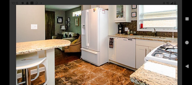 1424 Jerele Ave, Berkeley, IL 60163 - kitchen with white appliances, a sink, white cabinets, glass insert cabinets, and backsplash