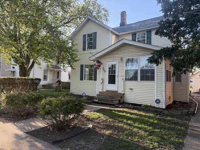 705 Campbell St, Joliet, IL 60435 - view of front of house featuring entry steps and a chimney