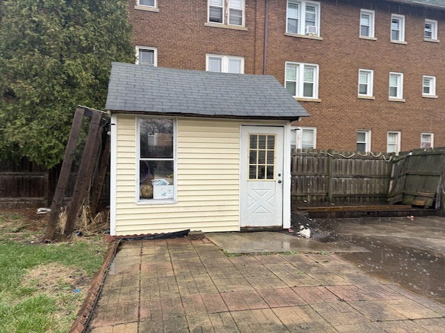705 Campbell St, Joliet, IL 60435 - back of property featuring a patio area, an outdoor structure, and a fenced backyard