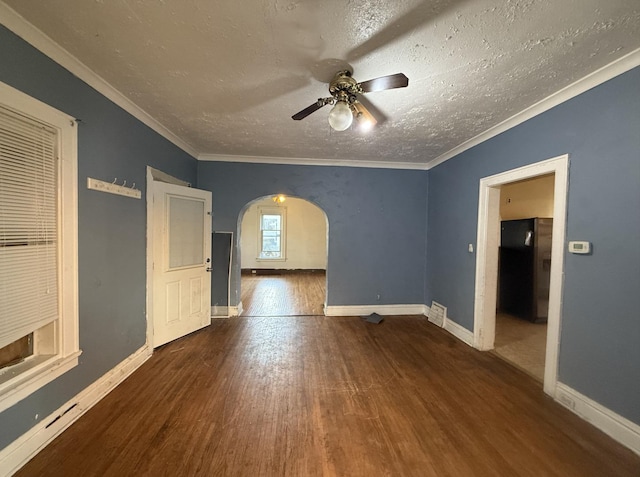 705 Campbell St, Joliet, IL 60435 - unfurnished room with arched walkways, wood finished floors, a textured ceiling, ceiling fan, and baseboards