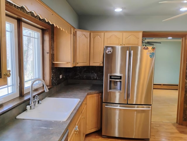 17W120 Woodland Ave, Bensenville, IL 60106 - kitchen with stainless steel fridge, baseboard heating, a sink, and healthy amount of natural light