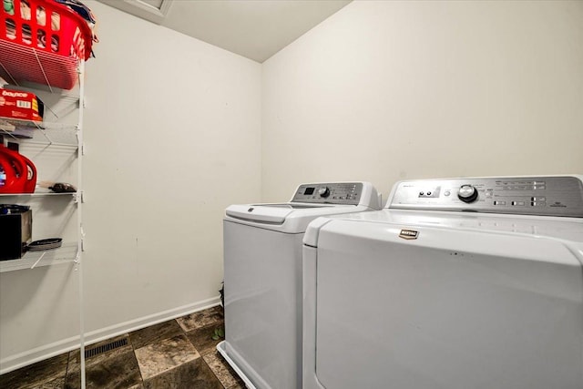 1651 Glenbrooke Ln, New Lenox, IL 60451 - laundry area featuring washer and dryer, dark stone finish floors, and baseboards