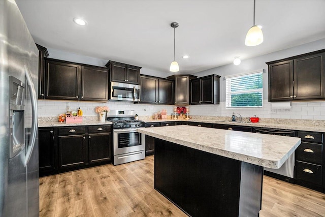 1651 Glenbrooke Ln, New Lenox, IL 60451 - kitchen with appliances with stainless steel finishes, a sink, light countertops, backsplash, and recessed lighting