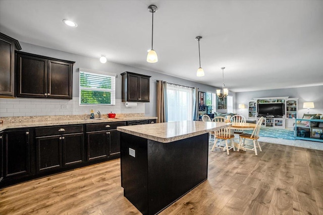 1651 Glenbrooke Ln, New Lenox, IL 60451 - kitchen featuring open floor plan, light countertops, a kitchen island, a sink, and plenty of natural light