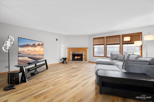 2355 Avalon Ct, Aurora, IL 60503 - living room featuring wood finished floors, a lit fireplace, and baseboards