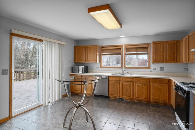 2355 Avalon Ct, Aurora, IL 60503 - kitchen featuring stainless steel dishwasher, gas range oven, a sink, and healthy amount of natural light