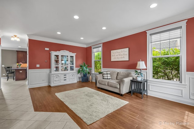 195 E Clover Ave, Cortland, IL 60112 - living area featuring crown molding, a wainscoted wall, recessed lighting, light wood-type flooring, and a decorative wall