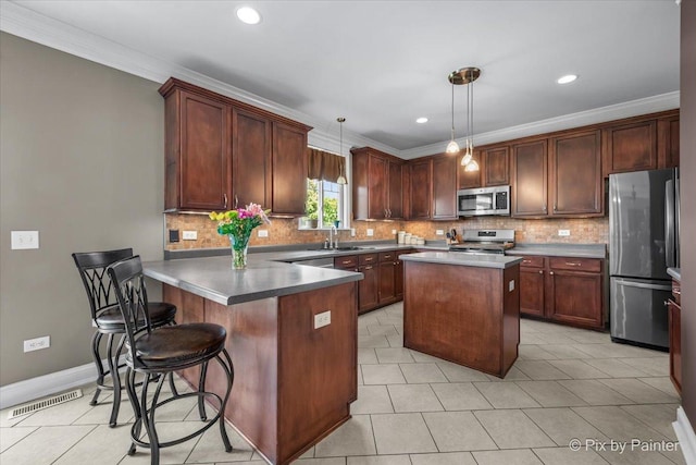 195 E Clover Ave, Cortland, IL 60112 - kitchen with stainless steel appliances, a sink, light tile patterned floors, a peninsula, and recessed lighting