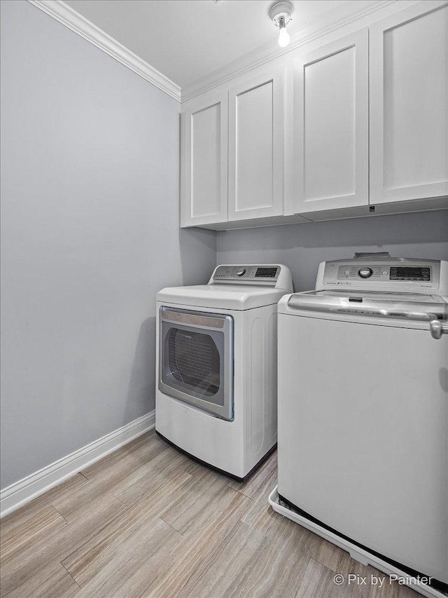 195 E Clover Ave, Cortland, IL 60112 - laundry area with cabinet space, washer and dryer, crown molding, light wood finished floors, and baseboards