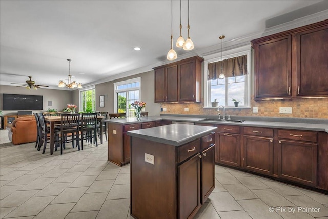 195 E Clover Ave, Cortland, IL 60112 - kitchen with a sink, a center island, backsplash, light tile patterned floors, and ornamental molding