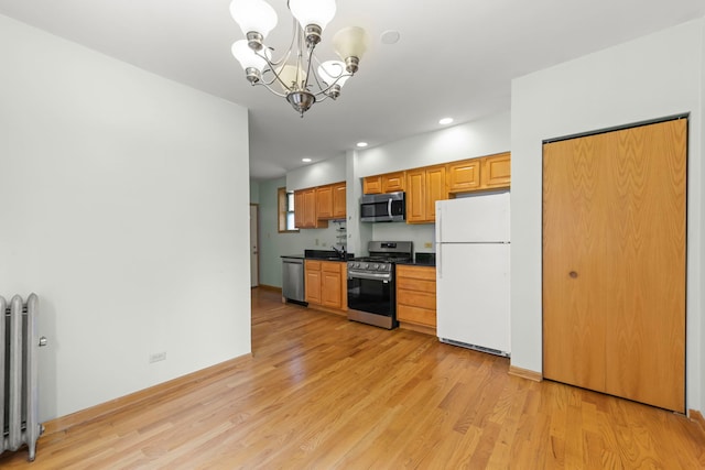 405 S Harvey Ave Unit 2A, Oak Park, IL 60302 - kitchen with stainless steel appliances, radiator, a chandelier, light wood finished floors, and dark countertops