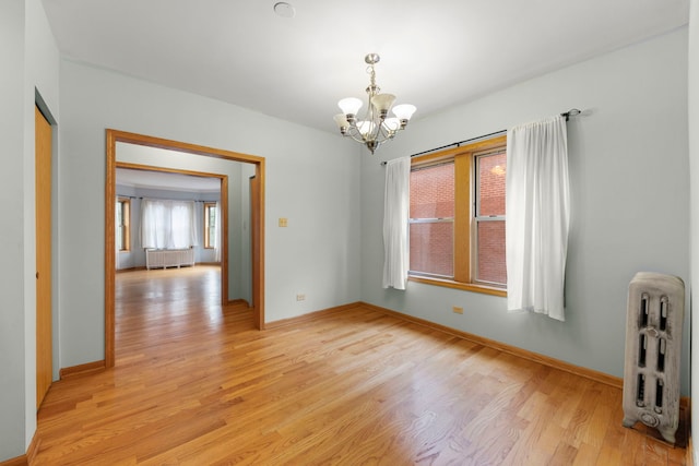 405 S Harvey Ave Unit 2A, Oak Park, IL 60302 - empty room featuring a chandelier, radiator, light wood-type flooring, radiator heating unit, and baseboards