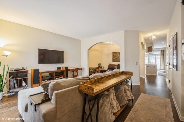 5932 N Sauganash Ln, Chicago, IL 60646 - living area with arched walkways, dark wood-type flooring, and baseboards