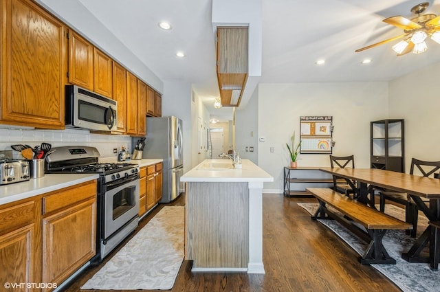 5932 N Sauganash Ln, Chicago, IL 60646 - kitchen featuring stainless steel appliances, backsplash, recessed lighting, a ceiling fan, and light countertops