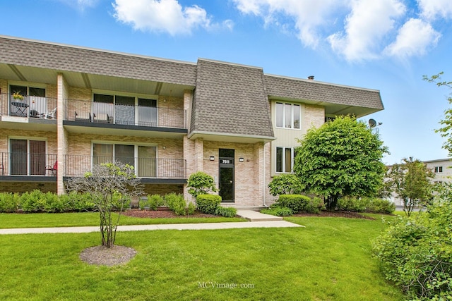 7811 W 157th St Unit 2N, Orland Park, IL 60462 - view of front of house featuring a front yard, brick siding, mansard roof, and a shingled roof
