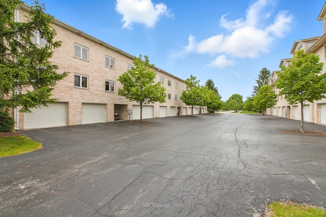 7811 W 157th St Unit 2N, Orland Park, IL 60462 - view of asphalt street featuring community garages