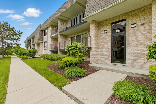7811 W 157th St Unit 2N, Orland Park, IL 60462 - property entrance with brick siding and roof with shingles