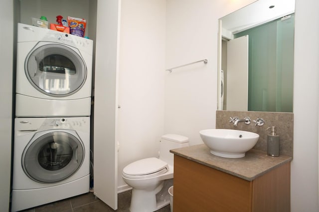 600 N Fairbanks Ct Unit 2503, Chicago, IL 60611 - bathroom with stacked washing machine and dryer, vanity, tile patterned floors, toilet, and tasteful backsplash