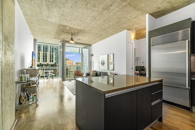 600 N Fairbanks Ct Unit 2503, Chicago, IL 60611 - kitchen with built in refrigerator, dark cabinetry, expansive windows, wood finished floors, and a ceiling fan
