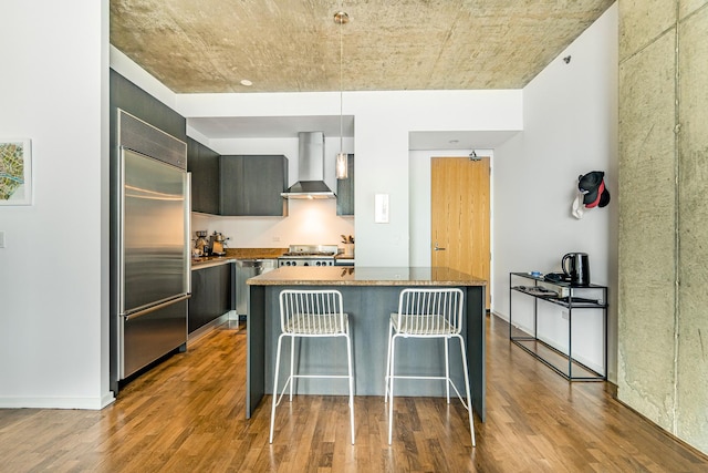 600 N Fairbanks Ct Unit 2503, Chicago, IL 60611 - kitchen with wall chimney range hood, stainless steel appliances, a breakfast bar, modern cabinets, and wood finished floors