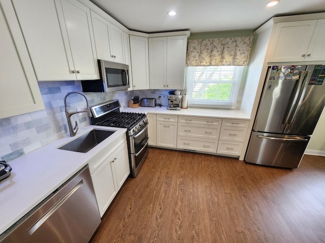 271 E Cleburne Ave, Bartlett, IL 60103 - kitchen featuring stainless steel appliances, a sink, light countertops, dark wood-type flooring, and backsplash