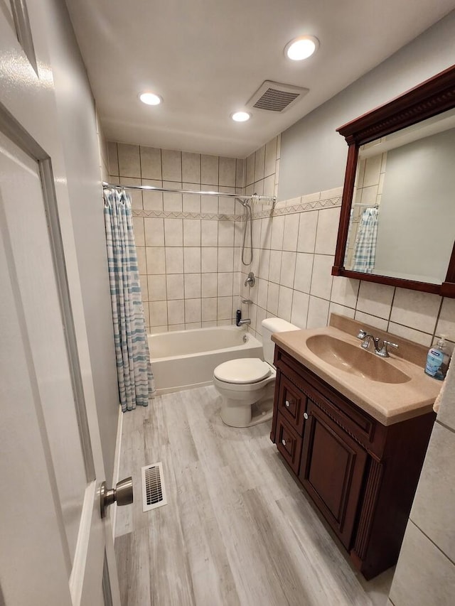 271 E Cleburne Ave, Bartlett, IL 60103 - full bath with toilet, vanity, shower / bath combo with shower curtain, tile walls, and wood finished floors