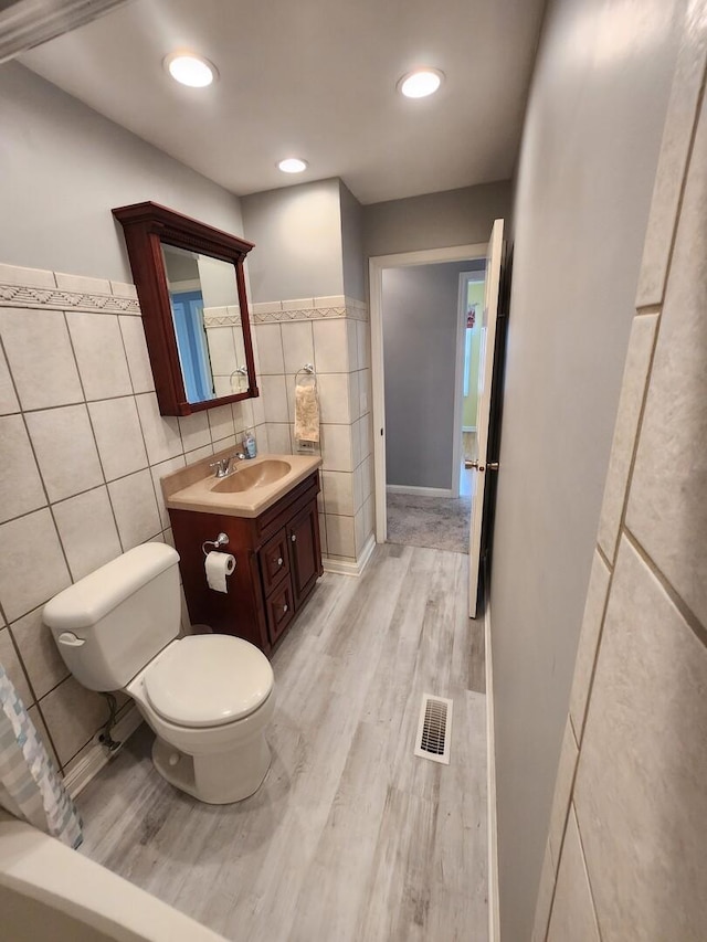 271 E Cleburne Ave, Bartlett, IL 60103 - bathroom with toilet, wood finished floors, vanity, and tile walls